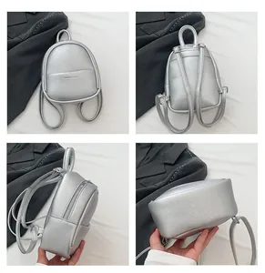 Detail view of mini silver backpack featuring pebbled leather texture and metallic finish