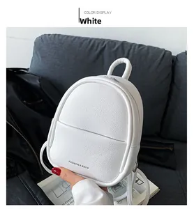 Detail of white mini backpack with pebble leather texture and metal zipper closure
