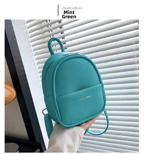 Detail of mint green lychee grain leather mini backpack with gold fashion lettering