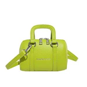 Lime green mini Boston bag in pebble leather with silver hardware and FASHION logo