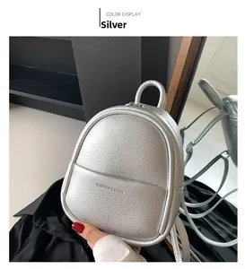 Detail of silver egg-shaped backpack with lychee texture and embossed fashion text