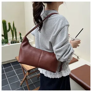 Retro brown faux leather underarm bag with sleek vertical stitching and slim straps