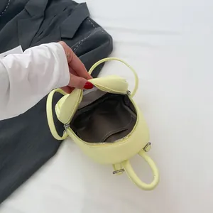 Mini egg-shaped lemon yellow backpack in lychee grain PU leather with zipper closure