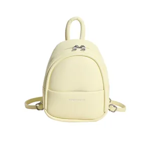 Chic cream yellow egg-shaped mini backpack in premium lychee grain PU leather with silver zips