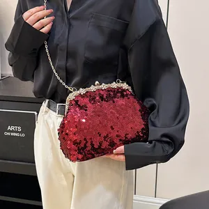 Rode avondtas met pailletten en gouden ketting met een bloemvormige strass-sluiting