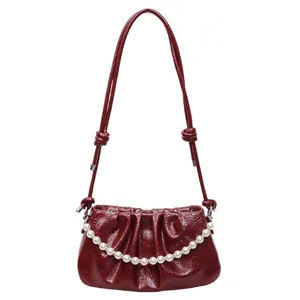 Glossy deep red pleated cloud bag with pearl chain and adjustable crossbody strap