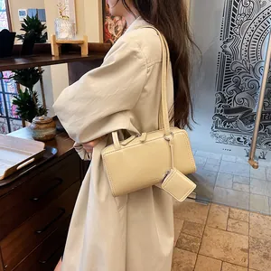 Chic cream rectangle shoulder bag with long straps and mini square pendant charm
