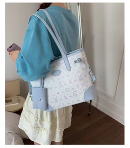 Detail of light blue contrast tote bag with bear patterns and mini hanging pouch