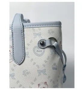 Detailed macro view of light blue bunny print on lychee pattern leather tote bag
