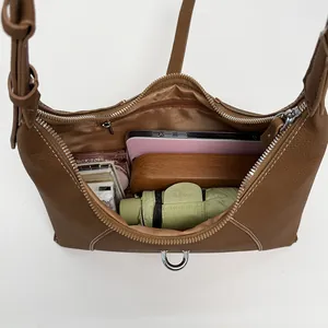 Brown leather underarm bag with spacious interior for umbrella, phone and daily essentials