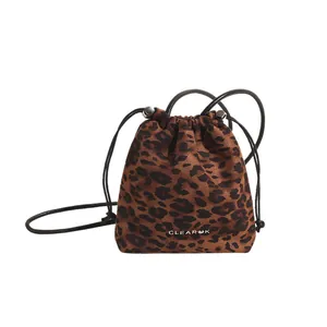 Chic leopard print drawstring bucket bag with adjustable black shoulder strap and silver accents