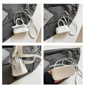 Détails du mini sac bowling en cuir verni blanc montrant les fermetures éclair argentées