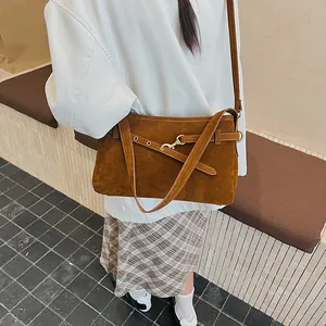 Vintage brown suede shoulder bag for women styled with casual minimalist outfit