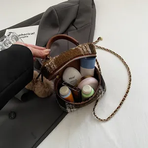 Sac bandoulière rétro en tweed avec chaîne montrant la capacité pour les cosmétiques