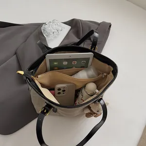 Retro canvas tote bag with large capacity, interior compartments and plush bear charm