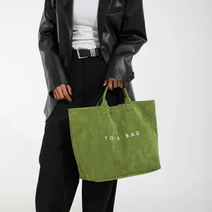 Borsa tote grande in velluto a coste verde con testo bianco e stile minimalista