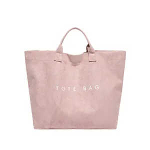 Borsa tote in pelle scamosciata rosa con scritta TOTE BAG bianca e due manici