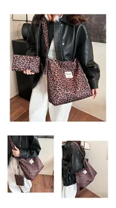 Detail set of leopard print canvas tote and matching clutch bag with fabric label