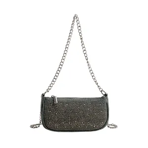 French design navy denim underarm bag with vintage metal rivets and silver chain strap