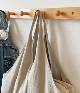 Detail of soft canvas tote bag featuring a smooth wide shoulder strap and large capacity
