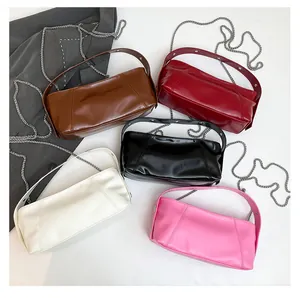 Close-up of stylish PU leather shoulder bags in brown, burgundy, black, cream and pink