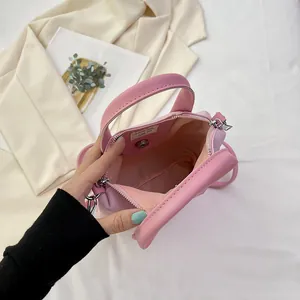 Pink mini crossbody bag featuring magnetic closure and premium inner lining