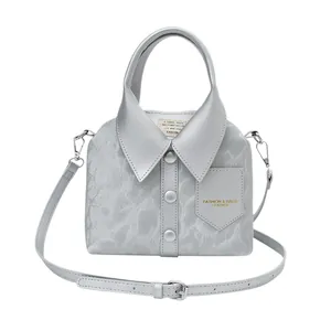 Metallic silver shirt-shaped handbag with collar and button details on white background