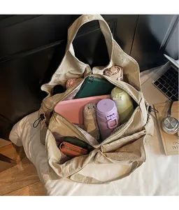 Detail view of large canvas bag interior with striped lining and multiple compartments
