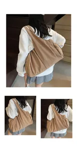 Close-up of large khaki canvas tote bag showing the textured fabric and casual slouchy style