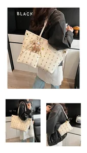 Detail of white tote bag set with bunny print, zip pouch and brown bear charm