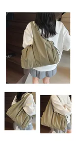 Detail of army green nylon pleated tote bag showing large capacity and drawstring texture