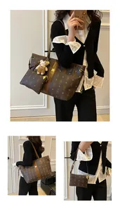 Detail of deep brown tote bag set with cartoon rabbit prints and small inner pouch
