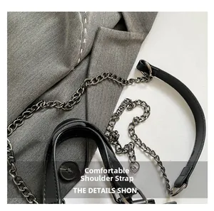Detail showing comfortable black leather shoulder strap with dark grey metal chain link