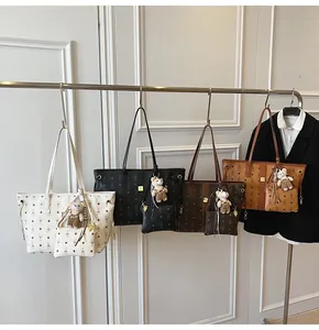 Detail of four colorful tote bags with bunny patterns, small pouches and bear charms