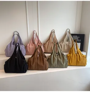 Collection of large nylon tote bags in eight colors featuring side drawstring pockets