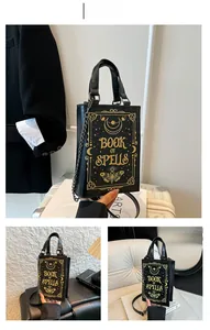 Macro view of book-shaped clutch featuring gold Book of Spells motifs and chain strap