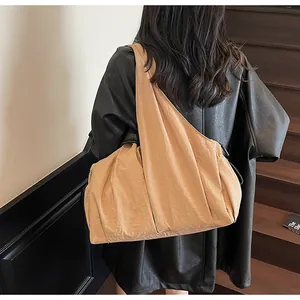 Caramel large canvas tote bag with wide shoulder strap shown on model back view
