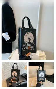 Detail of Halloween pumpkin print handbag with metal chain strap and festive design