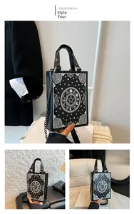 Close-up of black and white gothic bag with astrological moon and pentagram prints