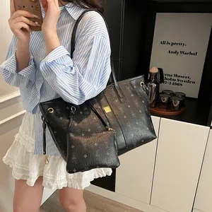 Fashionable black monogram tote bag set with a matching pouch and luxury leather texture