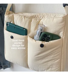 Detail of double front pockets with snap buttons on beige quilted puffer tote bag
