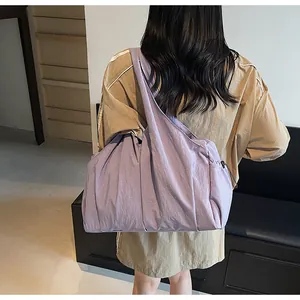 Detailed view of light purple large capacity nylon crescent bag with wide shoulder strap