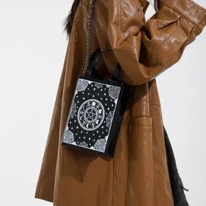 Gothic black crossbody bag with white moon and star prints and silver chain strap