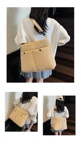 Detail of light beige quilted crossbody bag with dual pockets and adjustable straps