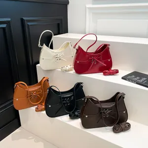 Elegant underarm bags with bow details in five colors including cream and brown