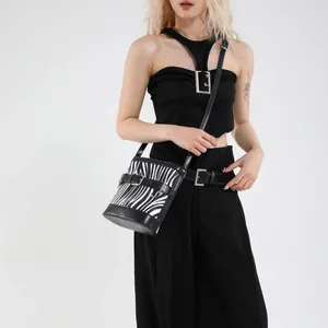 Stylish zebra print bucket bag with black leather trim and silver buckle detail
