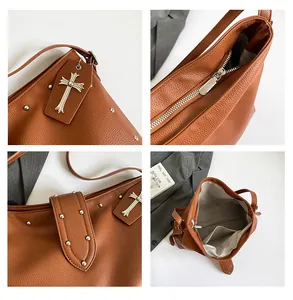 Detail van bruin litchileer met zilveren klinknagels en een kruisvormige hanger