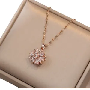 Elegant rose gold flower necklace with rotatable zircon petals on beige jewelry display