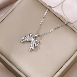 Detail of silver butterfly pendant with blue crystal and zircon inlays on gift box