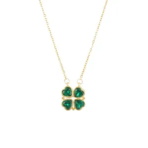 Elegant gold necklace with four-leaf clover pendant featuring green heart-shaped gems